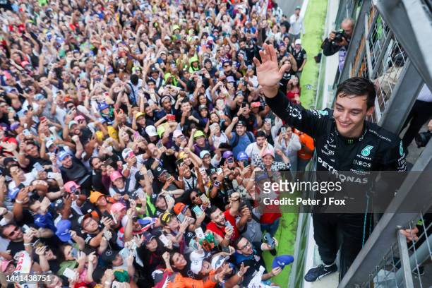 George Russell of Mercedes and Great Britain celebrates with the fans after winning his first Formula One Grand Prix during the F1 Grand Prix of...