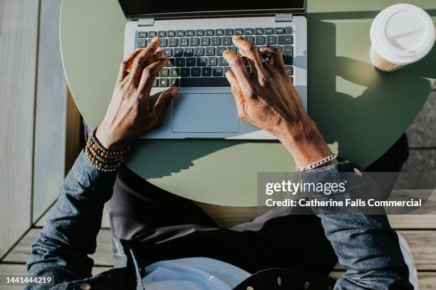 close-up of hands typing on a laptop computer - working on laptop in train top view stock pictures, royalty-free photos & images