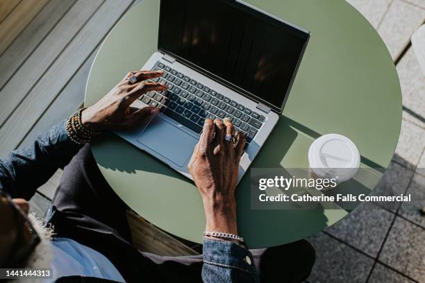 close-up of hands typing on a laptop computer - working on laptop in train top view stock pictures, royalty-free photos & images