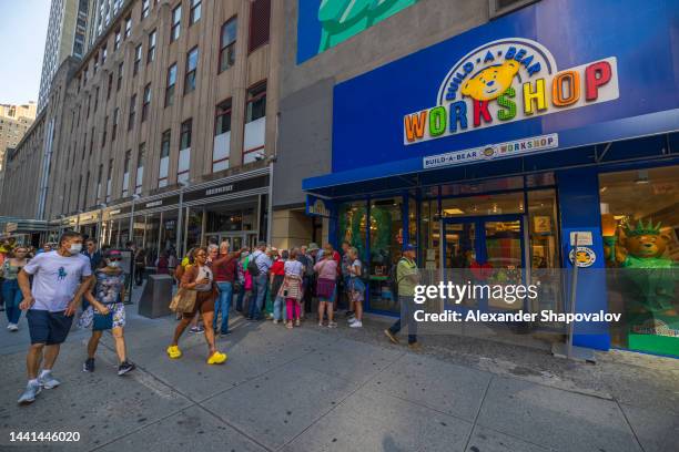 Close up view of people on street near entrance of build a bear workshop.