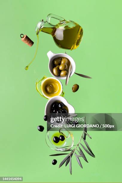 floating extra virgin olive oil with olives,italy - olive oil splash stock pictures, royalty-free photos & images