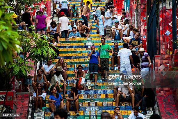 Tourists relax on Selaron's Stairs , a colorful mosaic tile stairway, on February 12, 2012 in Rio de Janeiro, Brazil. World famous staircase, mostly...