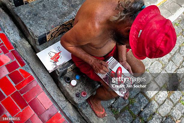 Jorge Selarón paints a picture in front of his house on Selaron's Stairs on February 13, 2012 in Rio de Janeiro, Brazil. World famous staircase,...