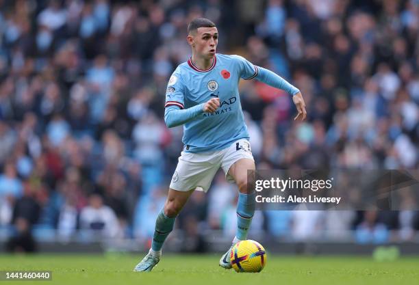 Phil Foden of Manchester City runs with the ballduring the Premier League match between Manchester City and Brentford FC at Etihad Stadium on...