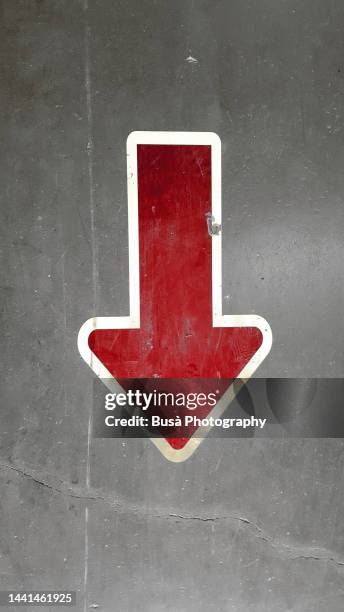 down arrow printed on asphalt - arrow down stock pictures, royalty-free photos & images