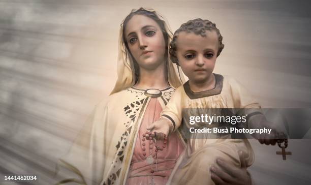 statue of virgin mary carrying baby jesus - purity stock pictures, royalty-free photos & images