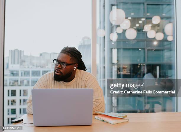 a young man works in a modern office environment - bewerbungsformular stock-fotos und bilder