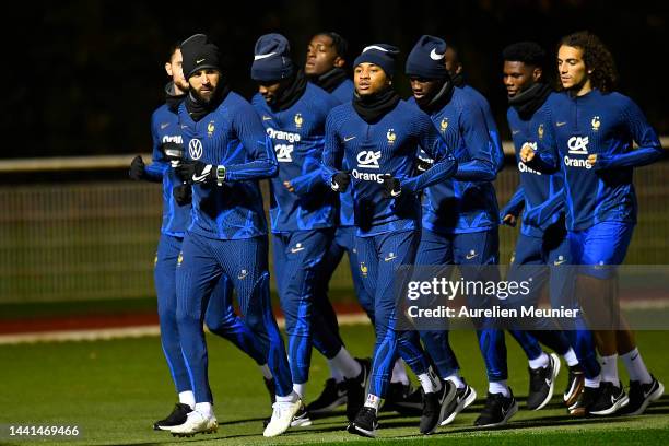 Karim Benzema, Christopher Nkunku and Matteo Guendouzi warmup during a french soccer team training session at Centre National Du Football on November...