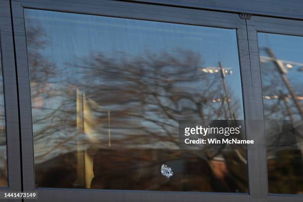 Bullet hole is shown in the window of a tour bus where three University of Virginia football players were killed in an overnight shooting at the...
