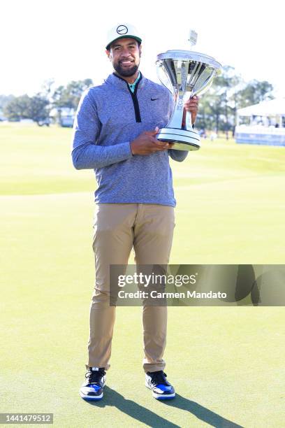 Tony Finau of the United States poses with the trophy after putting in to win on the 18th hole during the final round of the Cadence Bank Houston...