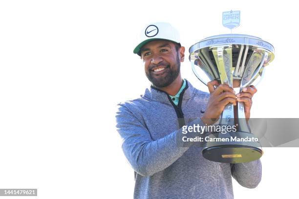 Tony Finau of the United States poses with the trophy after putting in to win on the 18th hole during the final round of the Cadence Bank Houston...