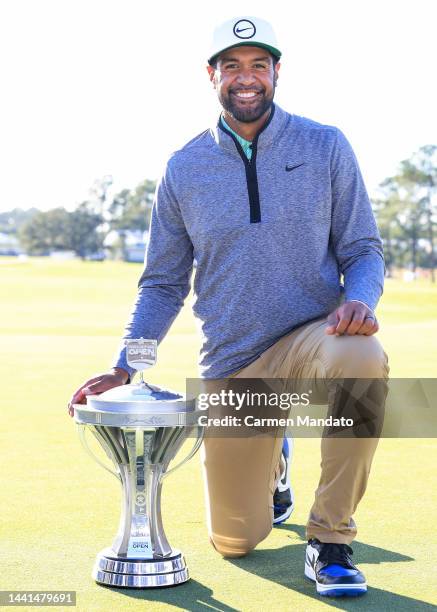 Tony Finau of the United States poses with the trophy after putting in to win on the 18th hole during the final round of the Cadence Bank Houston...