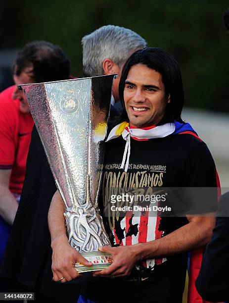 Radamel Falcao of Atletico Madrid holds the Europa League trophy while celebrating with fans at Plaza Neptuno a day after Atletico won the Europa...