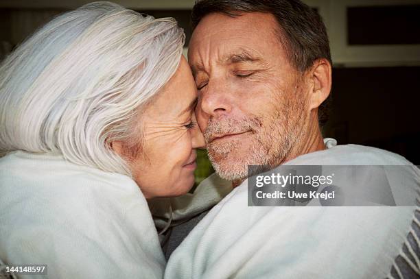 mature couple embracing, close-up - falling in love stock pictures, royalty-free photos & images