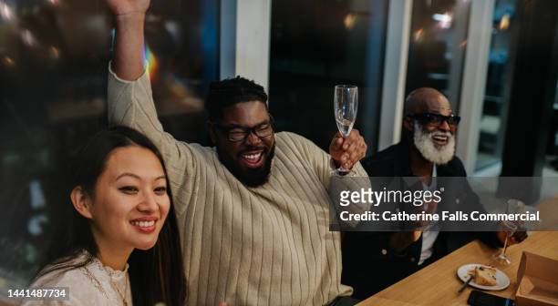 colleagues enjoy an after-work office party - party prop stock pictures, royalty-free photos & images