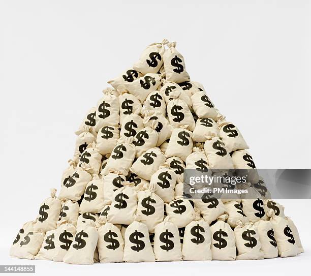 large pile of money bags in a pyramid shape. - sacco di soldi foto e immagini stock