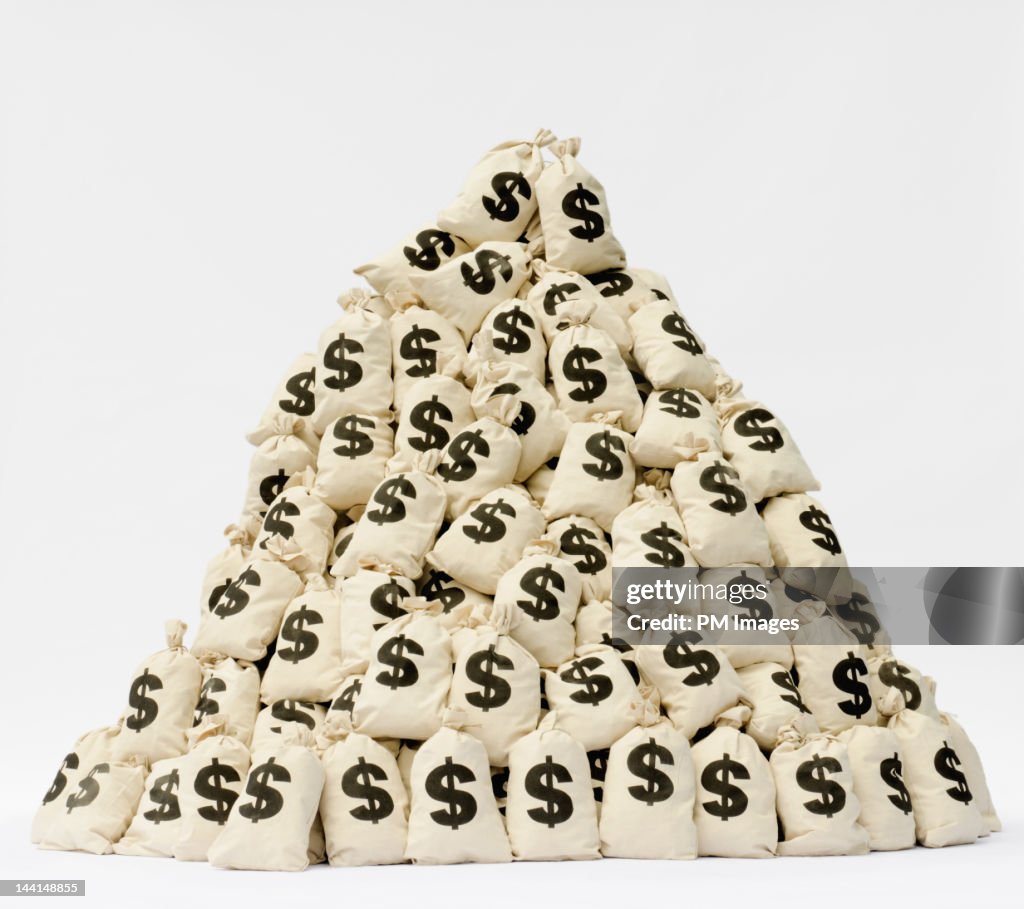 Large pile of money bags in a pyramid shape.