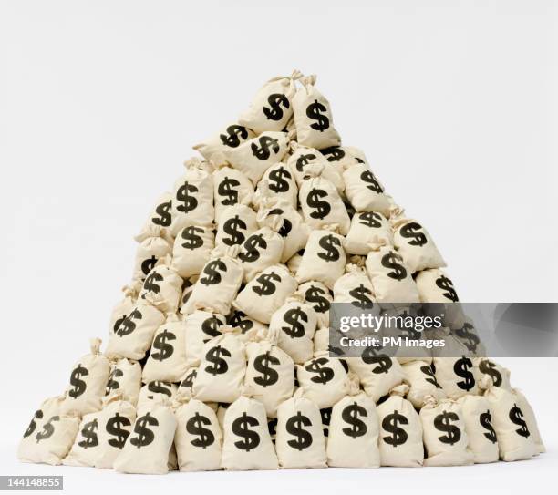 large pile of money bags in a pyramid shape. - heap stock pictures, royalty-free photos & images