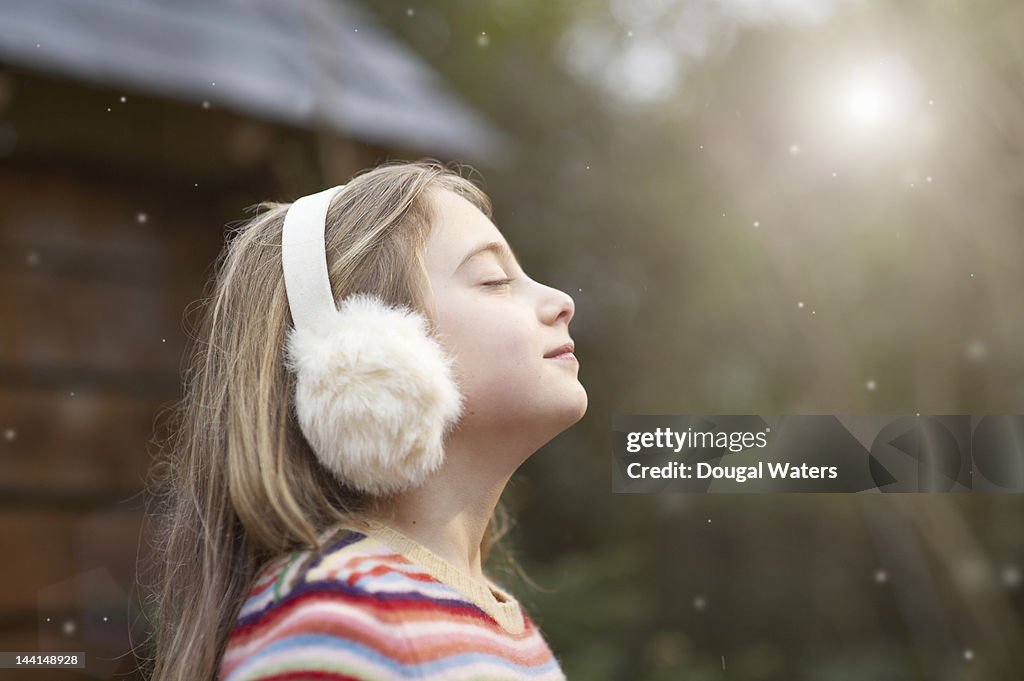 Profile of girl in winter setting with eyes closed