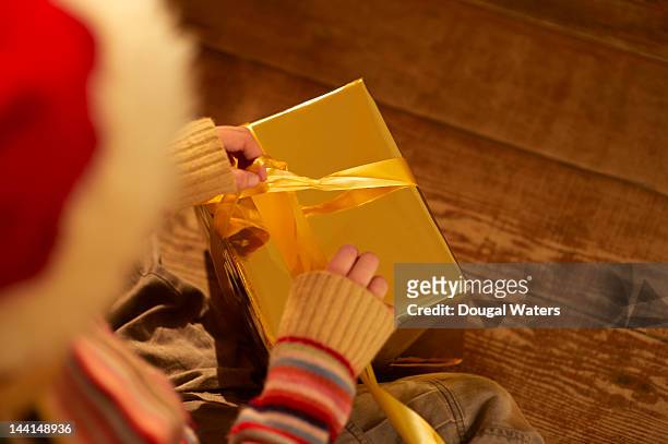child opening gift at christmas. - present unwrap stock-fotos und bilder