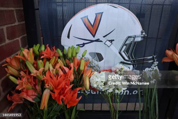 Flowers left outside Scott Stadium at a makeshift memorial for three University of Virginia football players killed during an overnight shooting at...
