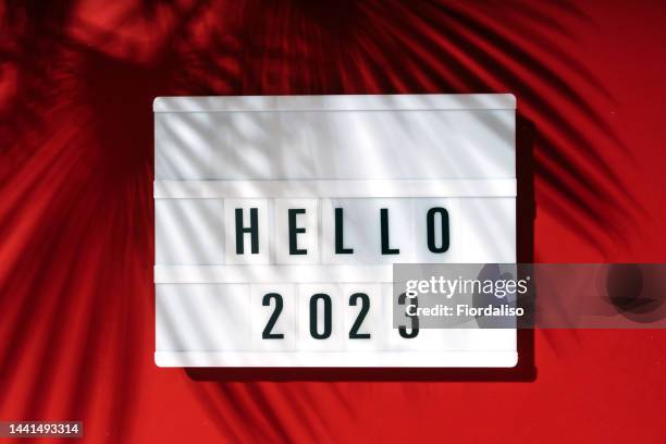 light box inscription hello 2023 on red background - light box stock pictures, royalty-free photos & images