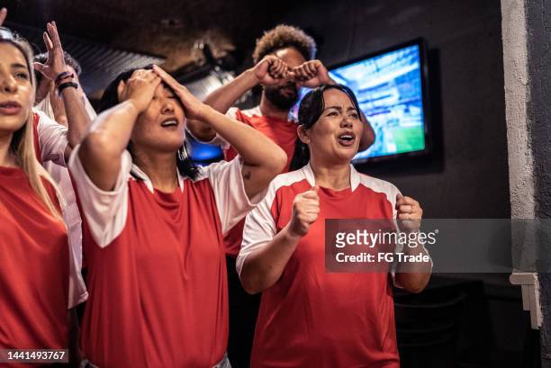 group of friends disappointed while rooting for their team - cross channel stock pictures, royalty-free photos & images