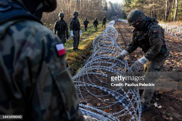 Soldiers of the Polish army installing concertina wire at Poland's border with Russian exclave Kaliningrad on November 14, 2022 in Goldap, Poland....