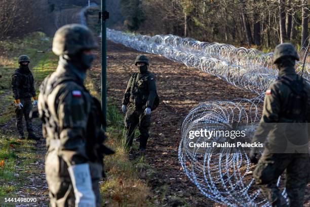 Soldiers of the Polish army installing concertina wire at Poland's border with Russian exclave Kaliningrad on November 14, 2022 in Goldap, Poland....