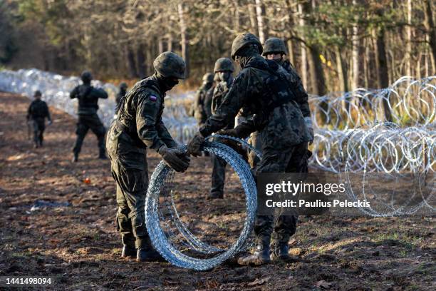 Soldiers of the Polish army installing concertina wire at Poland's border with Russian exclave Kaliningrad on November 14, 2022 in Goldap, Poland....