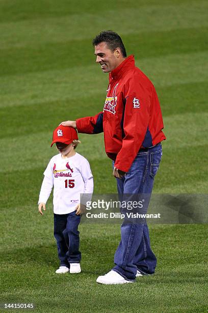 Former St. Louis Cardinals player Jim Edmonds and his son Landon participate in the first pitch ceremony prior to the Cardinals hosting the Milwaukee...