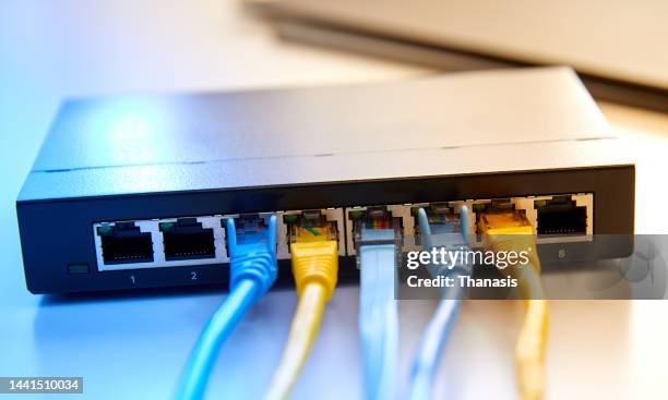 internet connection with the router via ethernet cables - wireless technology foto e immagini stock