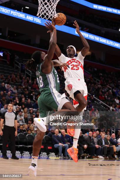 Chris Boucher of the Toronto Raptors drives to the basket against Isaiah Stewart of the Detroit Pistons during the first half at the Little Caesars...