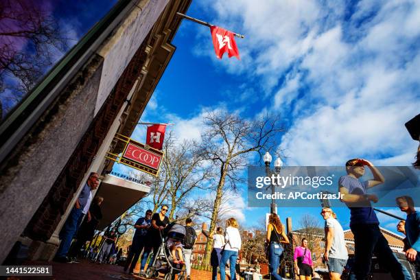 pedestrians in front of the harvard cooperative society building - harvard square - cambridge massachusetts - cambridge massachusetts stock pictures, royalty-free photos & images