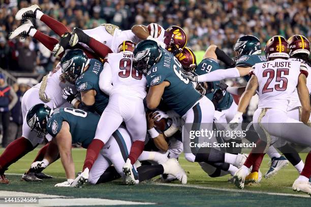 Jalen Hurts of the Philadelphia Eagles scores a touchdown against the Washington Commanders during the first quarter in the game at Lincoln Financial...