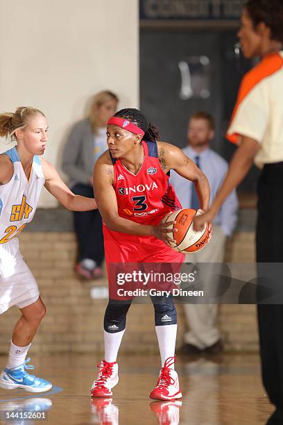 Dominique Canty of the Washington Mystics looks to pass while defended by Courtney Vandersloot of the Chicago Sky on May 10, 2012 at New Trier High...