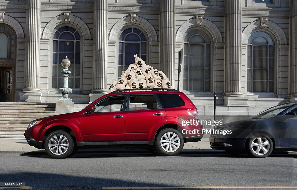 $ Money bags on car roof