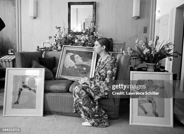 American singer and actress Barbra Streisand, in a flowered robe, sits on a sofa and writes a check for the purchase of a painting by Gustav Klimt...