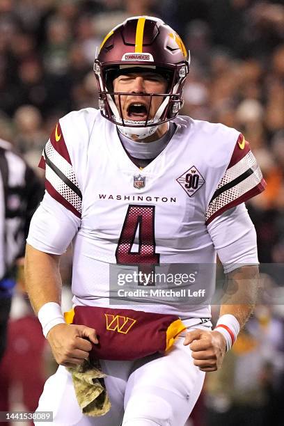 Taylor Heinicke of the Washington Commanders celebrates a touchdown scored by Brian Robinson Jr. #8 against the Philadelphia Eagles during the second...