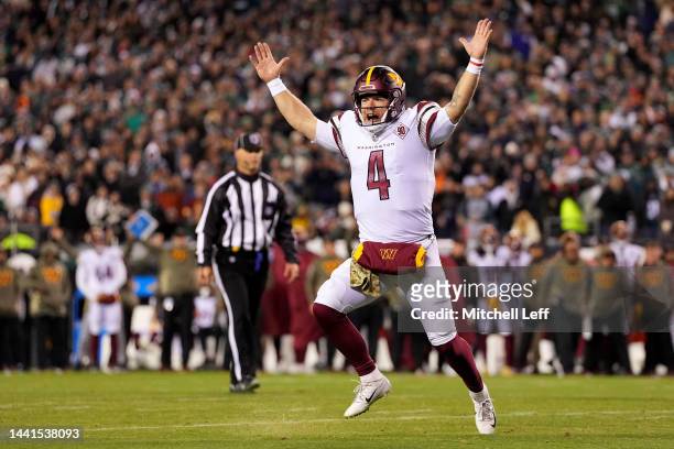 Taylor Heinicke of the Washington Commanders celebrates a touchdown scored by Brian Robinson Jr. #8 against the Philadelphia Eagles during the second...