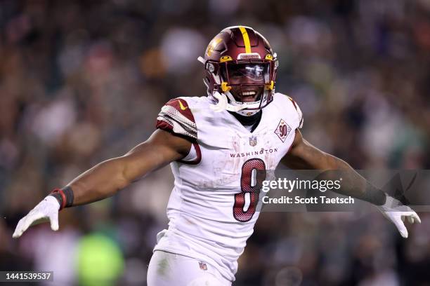 Brian Robinson Jr. #8 of the Washington Commanders celebrates after scoring a touchdown against the Philadelphia Eagles during the second quarter in...