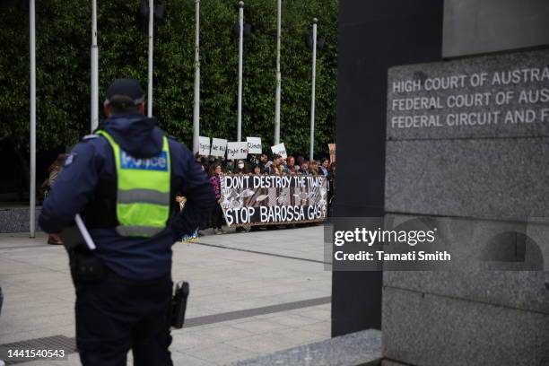 Protesters gather at the front of the Federal Court of Australia as police look onwards on November 15, 2022 in Melbourne, Australia. The Federal...