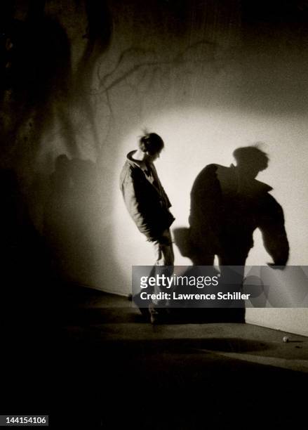 An unidentified man looks at his shadow during an LSD trip at an 'Acid Test' party on Sunset Blvd, Los Angeles, California, 1966. The man took the...
