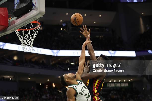Clint Capela of the Atlanta Hawks shoots over Giannis Antetokounmpo of the Milwaukee Bucks during the second half of a game at Fiserv Forum on...