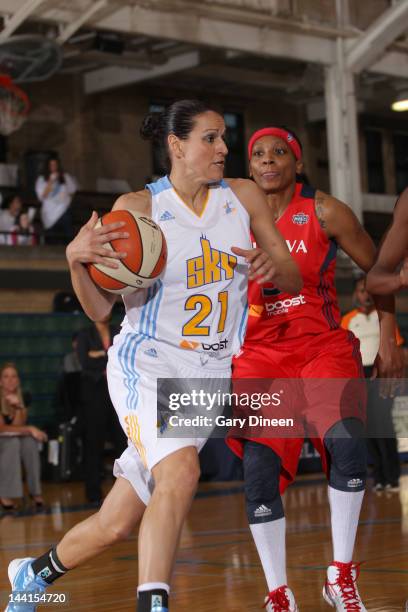 Ticha Penicheiro of the Chicago Sky drives past Dominique Canty of the Washington Mystics on May 10, 2012 at New Trier High School in Winnetka,...