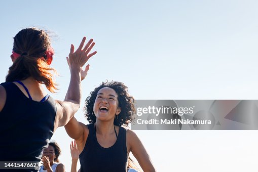 The women high-five and rejoice with each other. The women high-five and rejoice with each other.