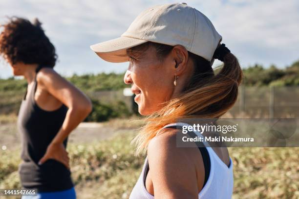 portrait of a woman gazing into the distance. - hair back stock pictures, royalty-free photos & images