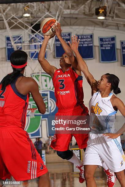 Dominique Canty of the Washington Mystics goes to the basket over Sydney Carter of the Chicago Sky on May 10, 2012 at New Trier High School in...