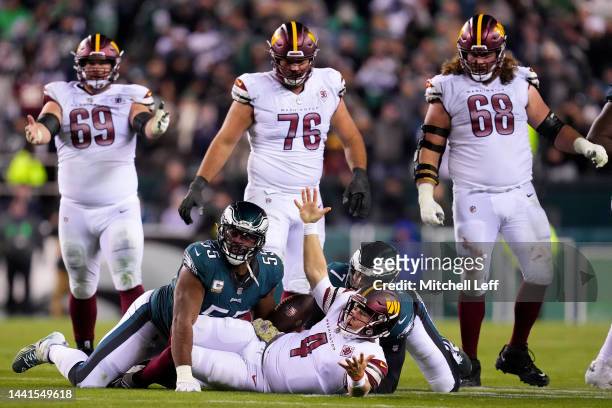 Taylor Heinicke of the Washington Commanders reacts to a late hit by Haason Reddick of the Philadelphia Eagles which was later ruled as unnecessary...