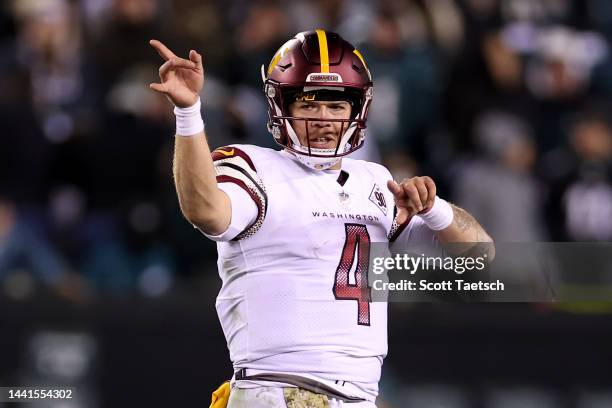 Taylor Heinicke of the Washington Commanders celebrates after an unnecessary roughness penalty was called against the Philadelphia Eagles during the...